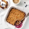 Blueberry Breakfast Crisp with a spoon in the white baking dish, along side of a bowl of breakfast crisp and a cup of coffee. Blueberry Crisp, Easy Blueberry Crisp, Healthy Blueberry Crisp, Healthy Food, Real Food, Real Food Recipes, Healthy Food Recipes, Wholesome food, Wholesome food recipes, Whole Food, Whole Food Recipes, Realgood food, Realfooddaily Eat real, Good Real Food, Goodrealfood,