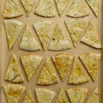 Unbaked and seasoned Pita Chips, spread out on a parchment lined pan. Healthy Food, Real Food, Real Food Recipes, Healthy Food Recipes, Wholesome food, Wholesome food recipes, Whole Food, Whole Food Recipes, Realgood food, Realfooddaily Eat real, Good Real Food, Goodrealfood, pita chips, pita, chips, homemade chips, homemade pita chips, from scratch pita chips, pita chip recipes, easy chip recipes, appetizer, from scratch appetizer