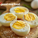 Hard-Boiled Eggs on a wooden serving tray, seasoned lightly with salt and pepper.