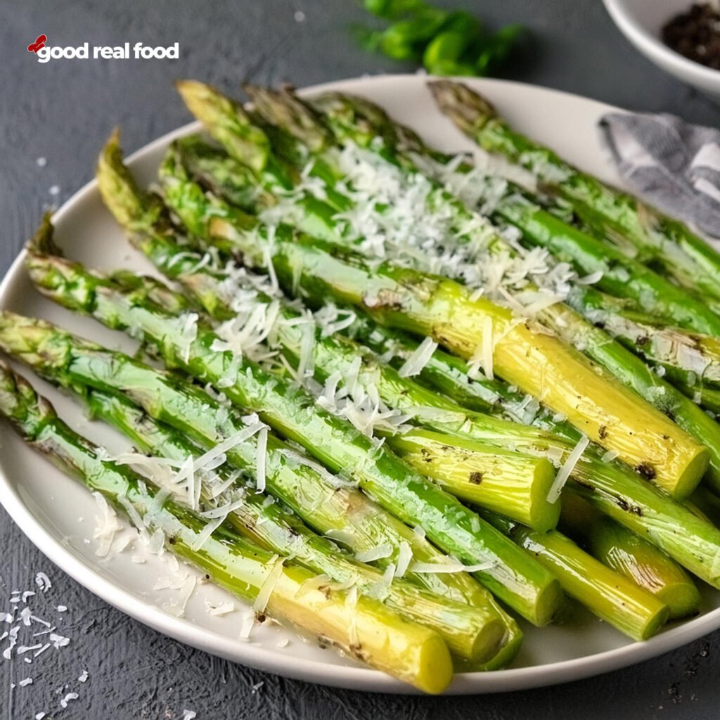 A plate of asparagus topped with parmesan.