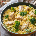 A skillet filled with chicken and broccoli orzo.