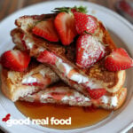 Strawberry cream cheese french toast on a white plate.