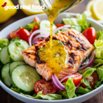 a salmon salad with a lemon vinaigrette pouring over the top.