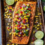 A sheet pan with Blackened Salmon topped with a corn salsa.