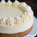 A close up image of classic cheesecake on a white plate.