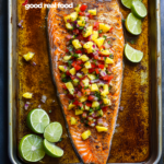 Chili lime salmon on a serving pan with limes.