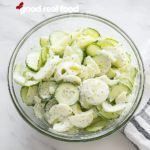 German cucumber salad in a large glass bowl.