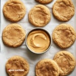 Peanut Butter Snickerdoodle displayed on parchment paper with a small bowl of peanut butter.