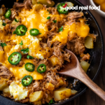 Pulled pork hash breakfast in a skillet.