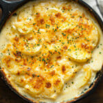 A skillet filled with au gratin potoatoes.