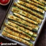 a pan of baked zucchini sticks.
