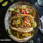 A plate of beef tacos, with all of the fixings.