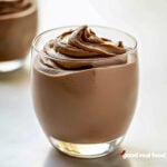 A clear dish filled with chocolate mousse.
