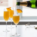 Pouring champagne into a mimosa