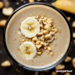 An overhead view of a peanut butter and banana smoothie.