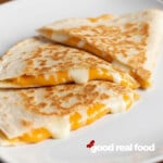 Cheese quesadillas on a white plate.