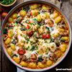 A white skillet filled with Tuscan sausage gnocchi.