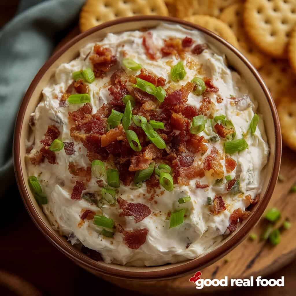 A bowl of crack dip with crackers.