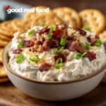 A bowl of crack dip with crackers.
