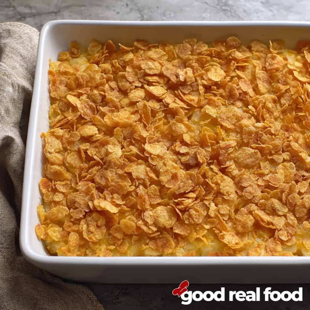 A white baking dish filled with funeral potatoes.