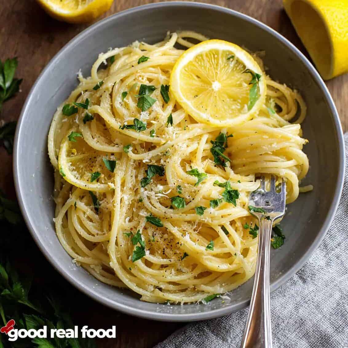 A bowl of spaghetti Limone with fresh lemons.