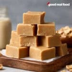A cutting board with peanut butter fudge stacked on top.