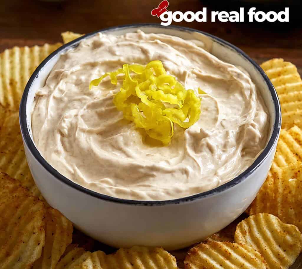 A bowl of Mississippi Pot Roast Dip with potato chips.