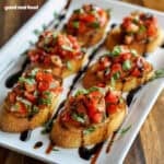 Bruschetta on a white serving platter.