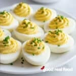 Deviled eggs on a white plate.