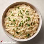 A ceramic bowl of Orzo Alfredo.