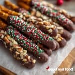 Chocolate Covered Pretzel Rods on a cutting board.
