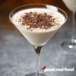 A white chocolate martini lightly garnished with chocolate.
