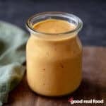 a glass jar filled with homemade bang bang sauce.