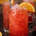 A mason jar filled with an Alabama slammer cocktail.