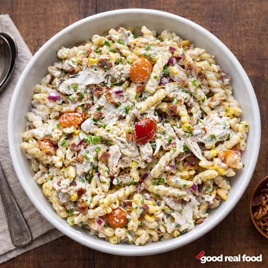 A white bowl of chicken bacon ranch pasta salad.