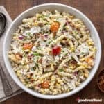 A white bowl of chicken bacon ranch pasta salad.