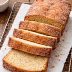 A loaf of donut bread, partially sliced.