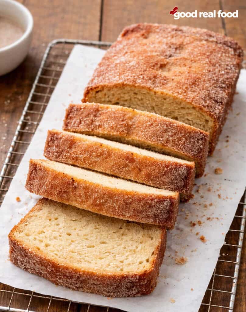A loaf of donut bread, partially sliced.
