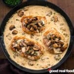 A skillet filled with creamy ranch and mushroom pork chops.