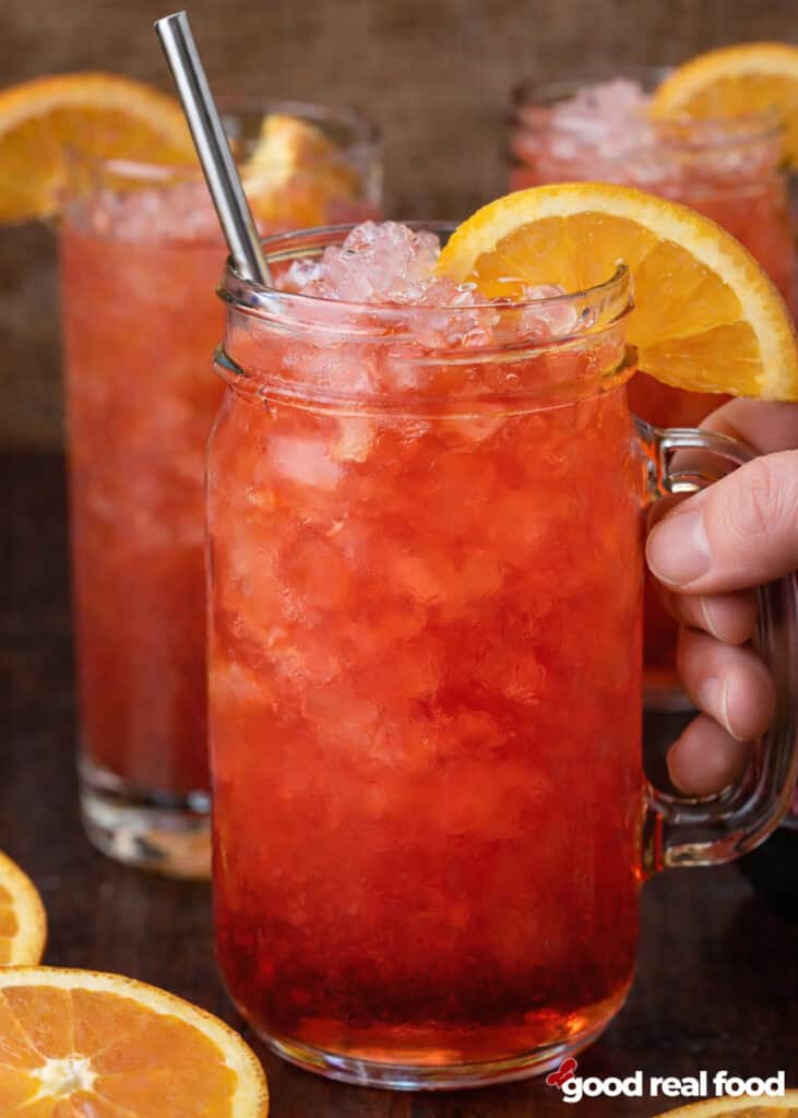 A mason jar filled with an Alabama slammer cocktail.