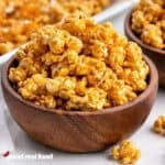 A wooden bowl of caramel corn.
