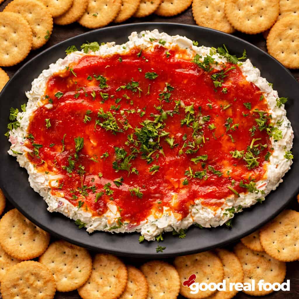 a black platter of crab dip