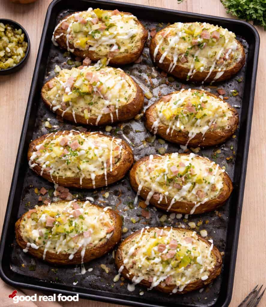 Ham and Pickle Twice Baked Potatoes on a sheet pan.