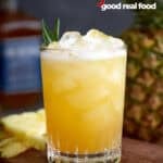 A glass of pineapple bourbon punch.
