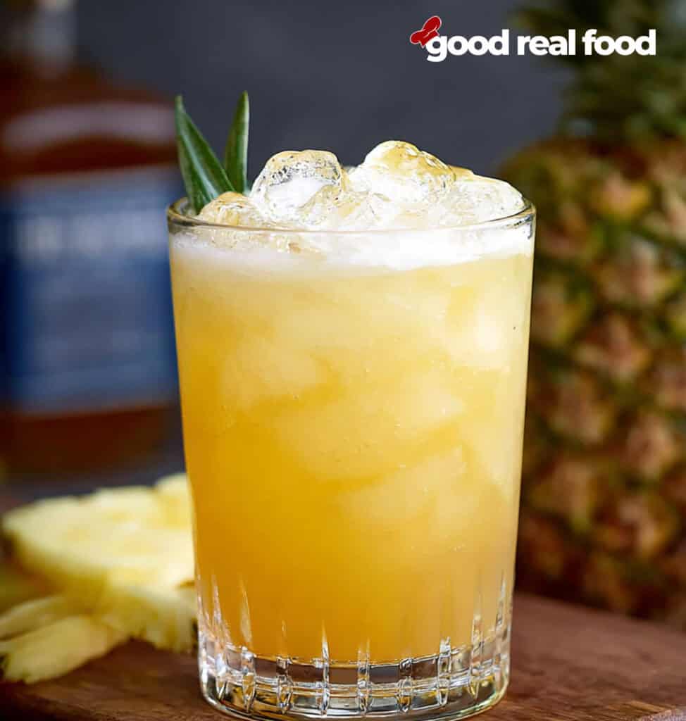 A glass of pineapple bourbon punch.