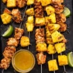 Pineapple and salmon skewers on a platter.