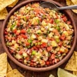 A wooden bowl filled with pineapple salsa.