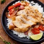 Sheet Pan Blackened Chicken on a plate served over rice.