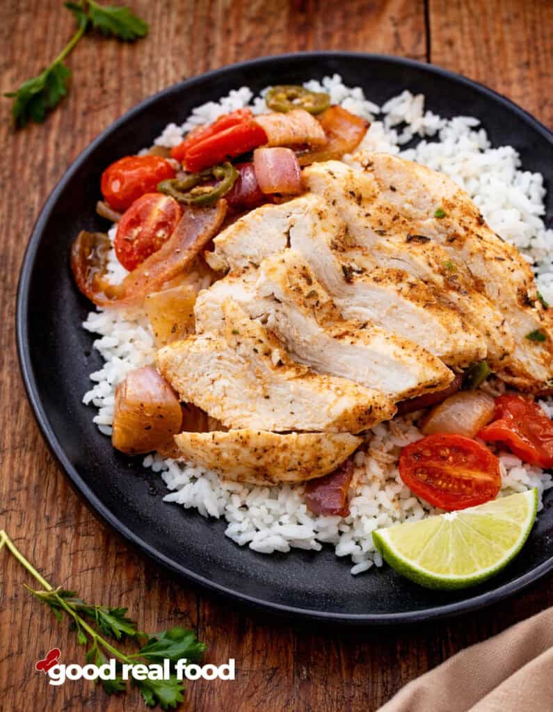 Sheet Pan Blackened Chicken on a plate served over rice.