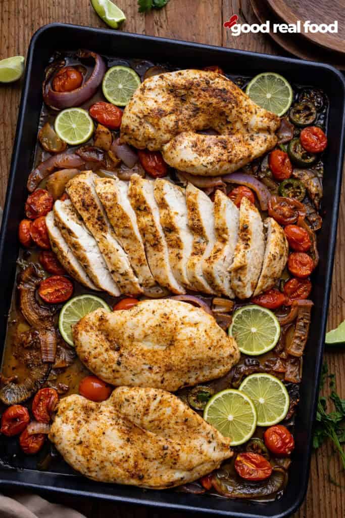 A sheet pan filled with Sheet Pan Blackened Chicken and veggies.